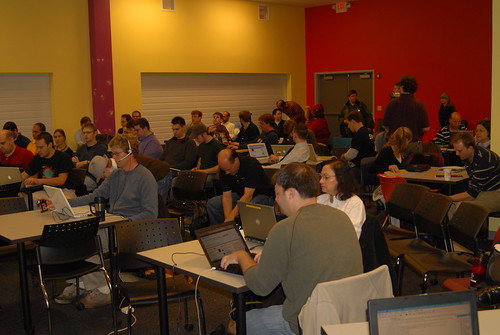 image of Jam attendees sitting at tables with laptops