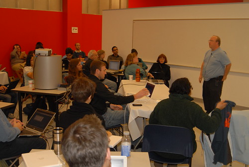 image of Jam attendees engaged in listening to a man presenting at the front of the room