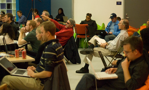 image of Jam attendees sitting in chairs, taking notes on laptops