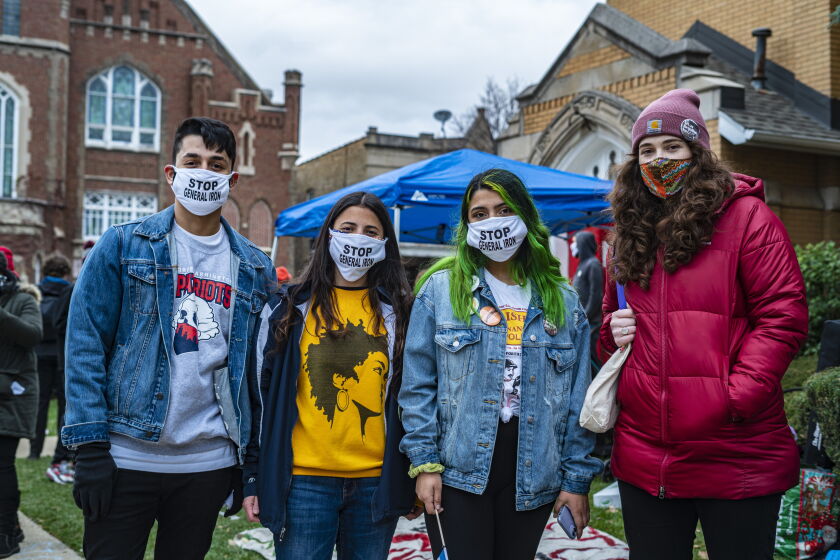 Teacher Lauren Bianchi, far right, stands with fellow George Washington High School teachers and a student, second from right, to protest General Iron's planned move to the Southeast.