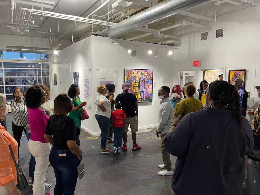 Participants from a previous tour of the Bronzeville art district inside the Guichard Gallery, one of five neighborhood galleries participating in the monthly event. 