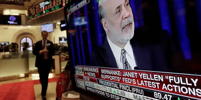 Federal Reserve Chairman Ben Bernanke's press conference appears on a television screen in a trading post on the floor of the New York Stock Exchange, Wednesday, Dec. 18, 2013. (AP Photo/Richard Drew)