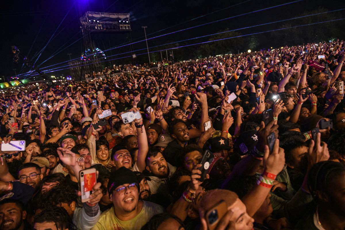 The crowd watches Travis Scott perform at the Astroworld Festival at NRG Park on Friday night in Houston.  Several people died and many more were injured in what officials described as a crowd surge at the music festival as Scott performed.