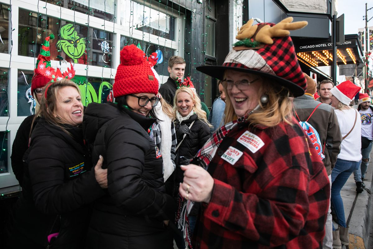Beth Montgomery, right, lines up with friends outside a Clark Street bar on Saturday in Wrigleyville.